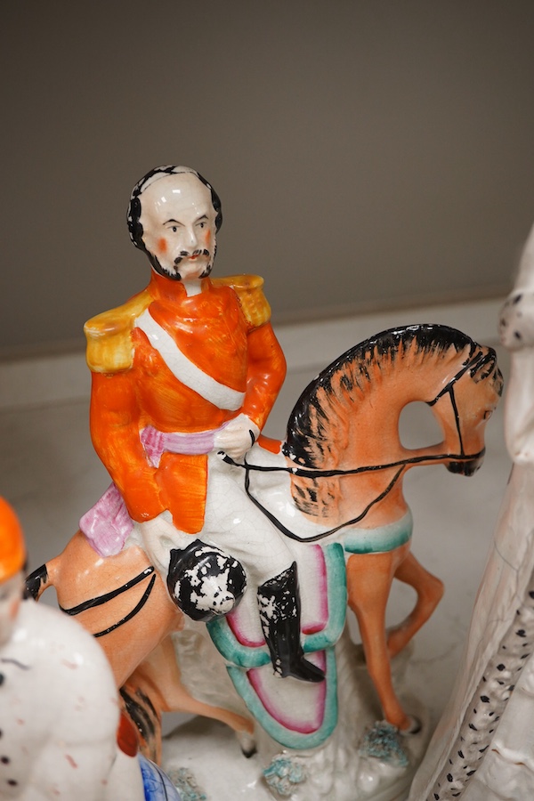 A collection of seven Staffordshire figures, including Queen Victoria - 45cm high, a cricketer, a boy reading, Tom King etc